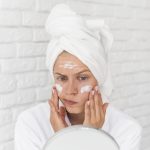 close-up-woman-putting-face-mask
