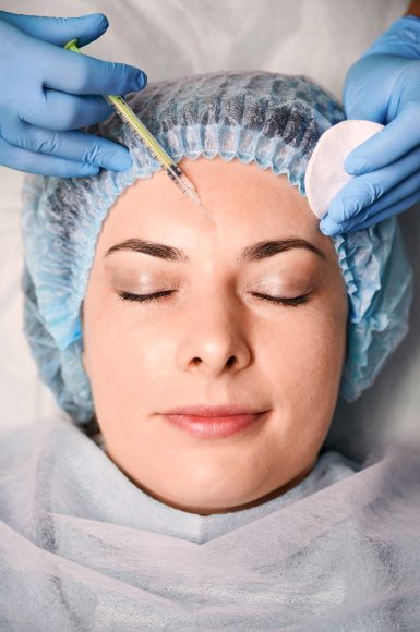 Female client getting beauty injection at wellness center.