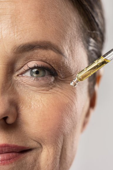 smiley-elder-woman-using-serum-her-eye-wrinkles (1)
